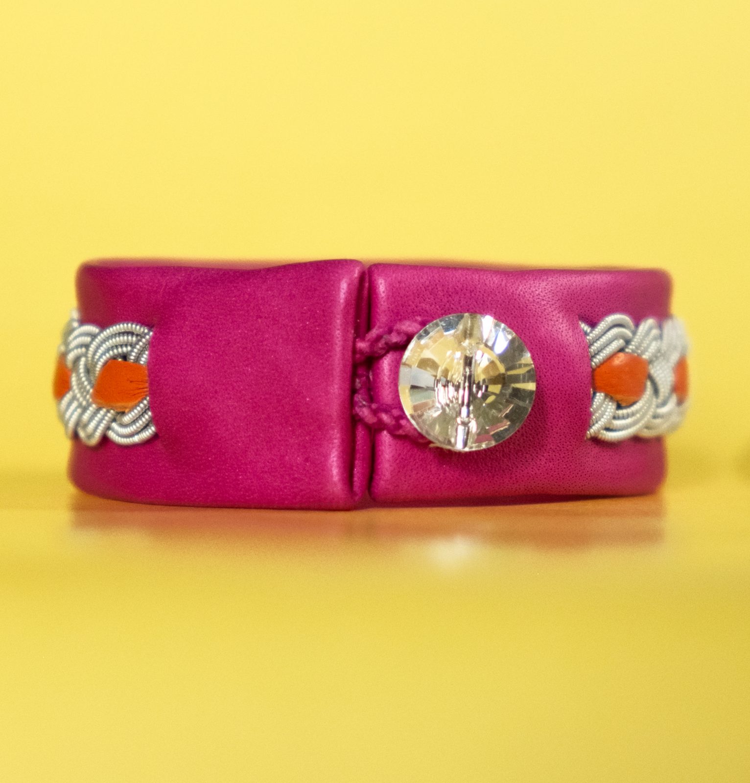 EVA-LOTTA - Cerise / Magenta / Pink coloured tin thread bracelet with orange details and Swarovski-style glass button